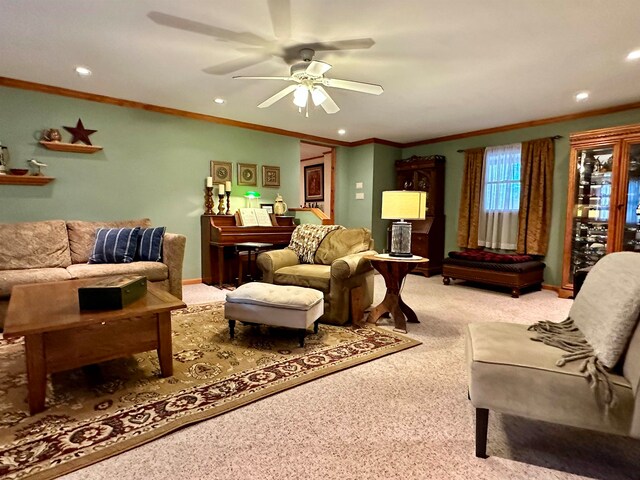 carpeted living room with ceiling fan and crown molding