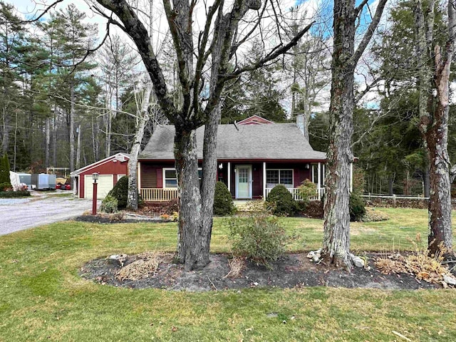 ranch-style house featuring a porch, a garage, and a front lawn