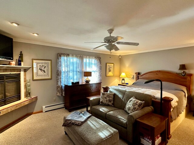 carpeted bedroom featuring ceiling fan, a tiled fireplace, ornamental molding, and a baseboard heating unit