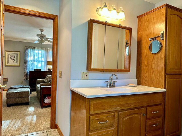 bathroom with tile patterned flooring, vanity, and ceiling fan