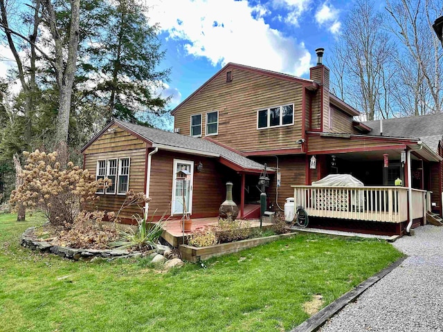 rear view of property with a yard