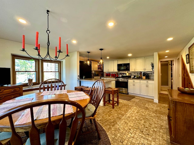 dining space with an inviting chandelier