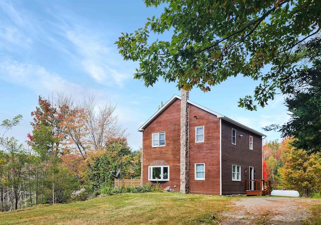 view of side of home with a yard