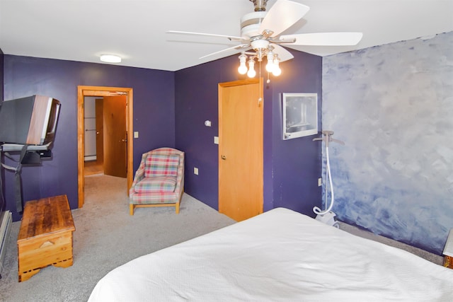 carpeted bedroom featuring baseboard heating and ceiling fan