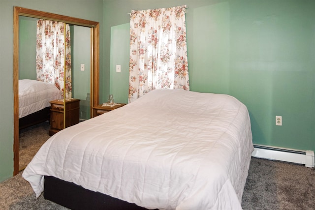 carpeted bedroom with baseboard heating and a closet