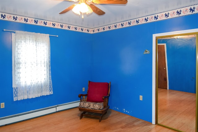 unfurnished room with hardwood / wood-style flooring, ceiling fan, and baseboard heating