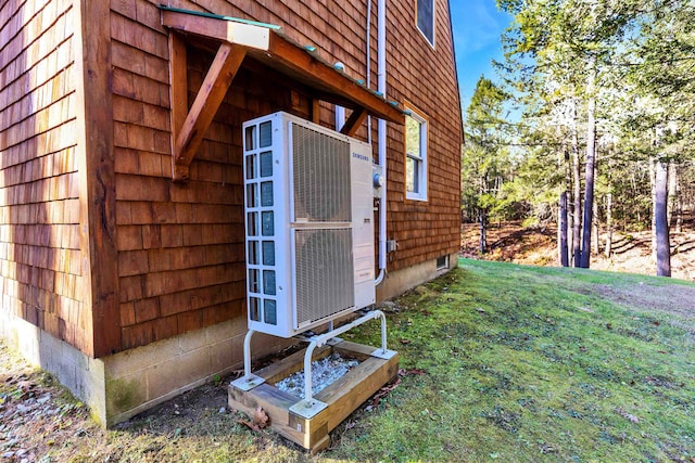 view of property exterior with a lawn and ac unit