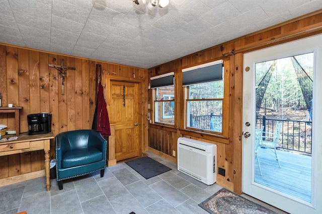 entryway with wood walls and heating unit