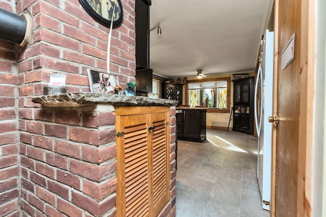 interior space featuring stone counters and white fridge