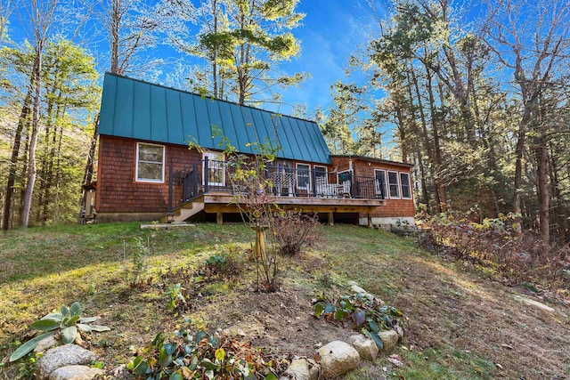 rear view of property with a wooden deck