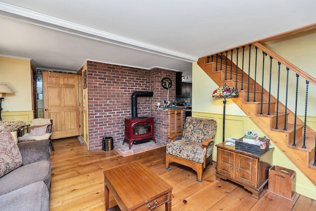 living room featuring a wood stove and light hardwood / wood-style floors