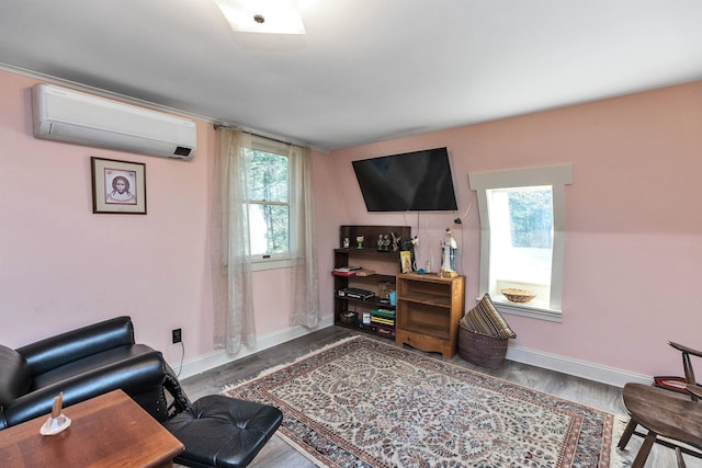 office area featuring a wall mounted air conditioner, hardwood / wood-style floors, and plenty of natural light