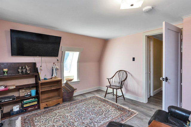 living area with hardwood / wood-style flooring and vaulted ceiling