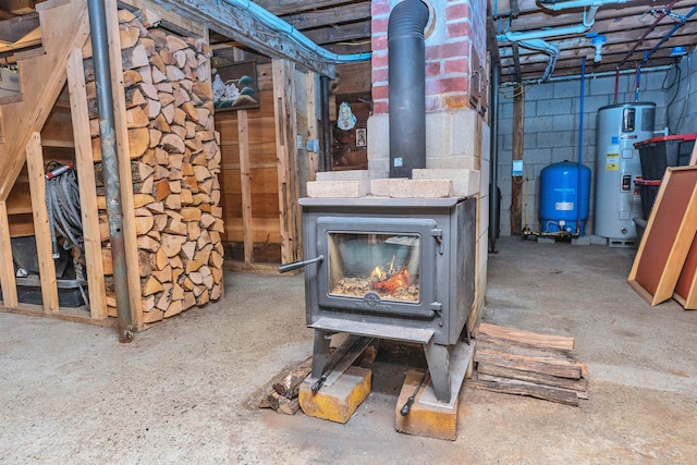 basement with a wood stove and heat pump water heater