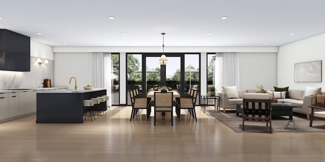 dining area with light hardwood / wood-style flooring and sink