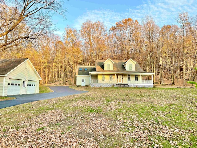 farmhouse featuring a porch and an outdoor structure