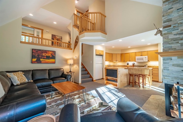 living room featuring light tile patterned floors and a high ceiling