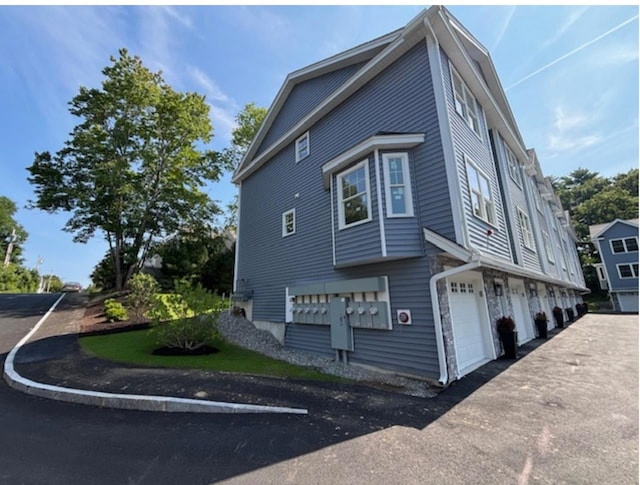 view of side of home featuring a garage