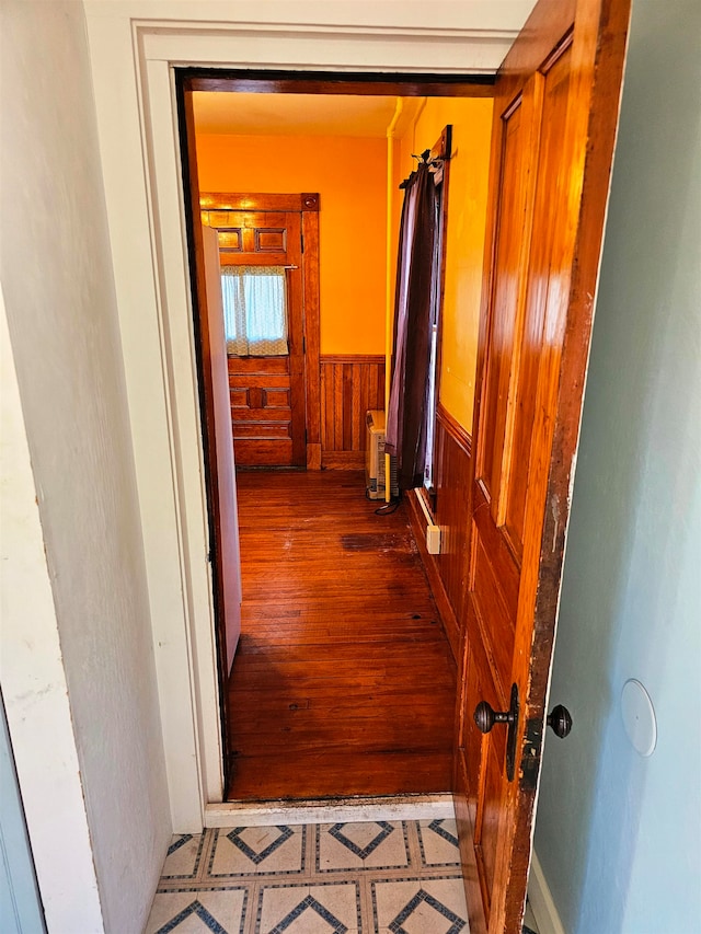 hallway featuring wooden walls and hardwood / wood-style flooring