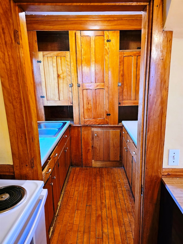 kitchen with white electric range oven and hardwood / wood-style floors