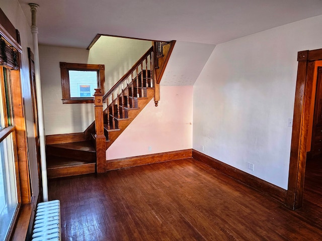 interior space with radiator and hardwood / wood-style flooring