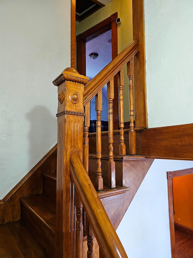 staircase with hardwood / wood-style flooring