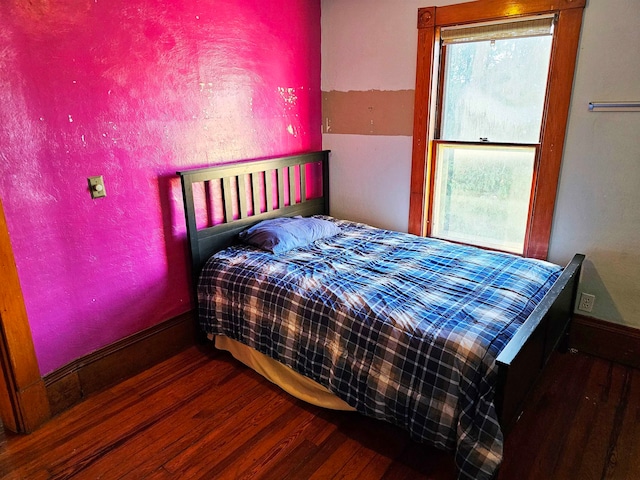 bedroom with dark hardwood / wood-style floors