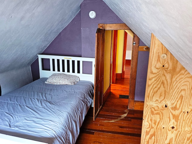 bedroom featuring vaulted ceiling and dark wood-type flooring