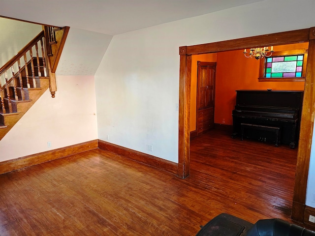 interior space featuring a chandelier, dark hardwood / wood-style floors, and vaulted ceiling