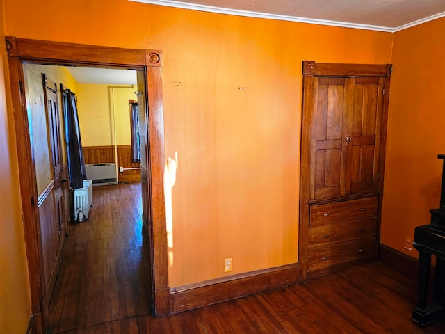 interior space featuring crown molding, radiator heating unit, and dark wood-type flooring