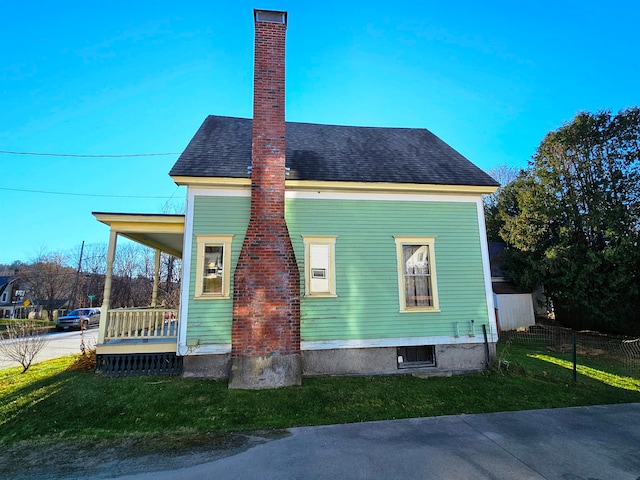 view of side of property with a yard and a porch