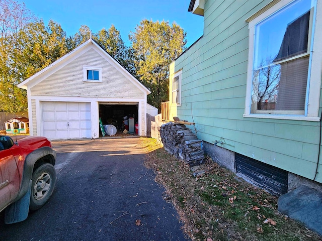 view of home's exterior with a garage and an outdoor structure