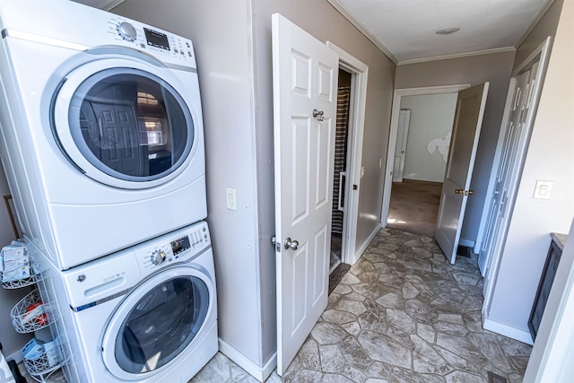 washroom featuring crown molding and stacked washing maching and dryer