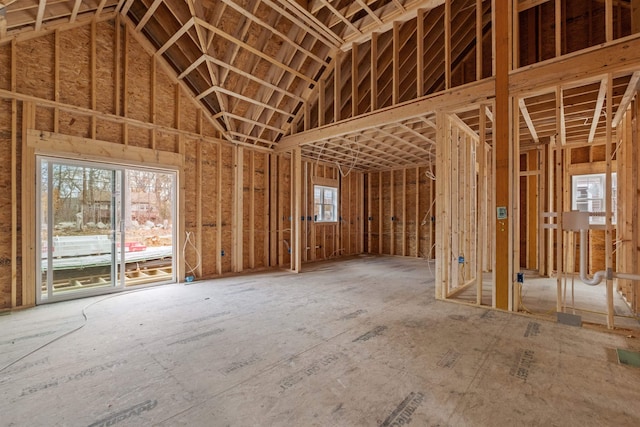 miscellaneous room with high vaulted ceiling and a healthy amount of sunlight