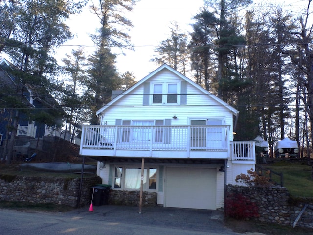 view of front of home featuring a garage and a wooden deck