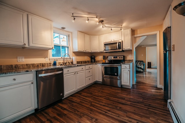 kitchen featuring white cabinets, stainless steel appliances, dark wood-type flooring, and a baseboard heating unit