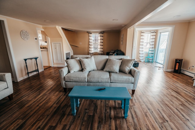 living room featuring a baseboard heating unit, hardwood / wood-style flooring, and ornamental molding