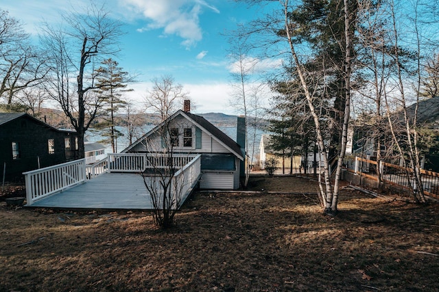 back of house with a wooden deck