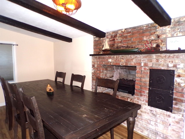 dining space with beamed ceiling and wood-type flooring