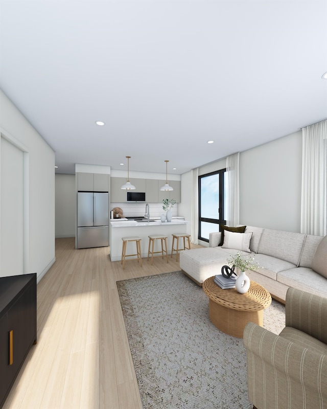 living room with sink and light wood-type flooring