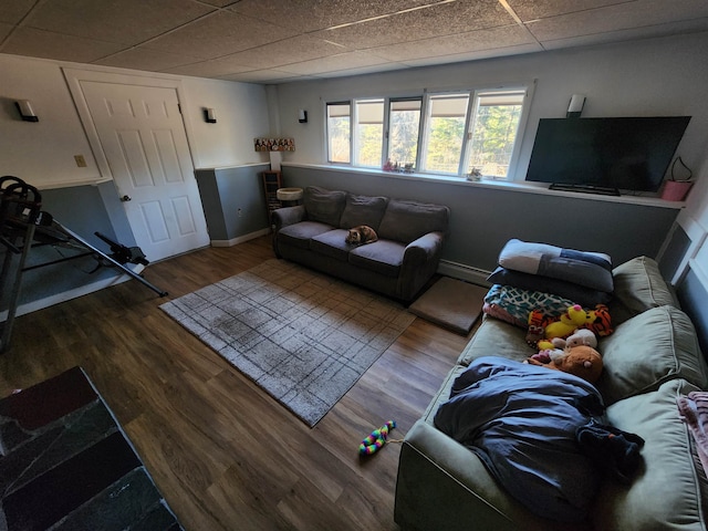 living room featuring wood-type flooring, a paneled ceiling, and a baseboard radiator