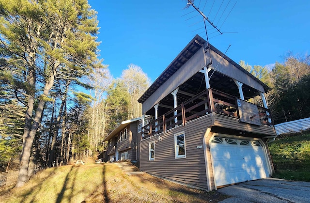 view of side of property with a balcony and a garage