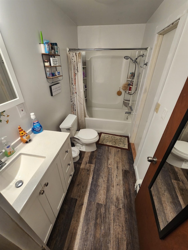 full bathroom with shower / tub combo, hardwood / wood-style floors, vanity, and toilet