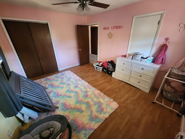 bedroom with light hardwood / wood-style flooring, a closet, and ceiling fan