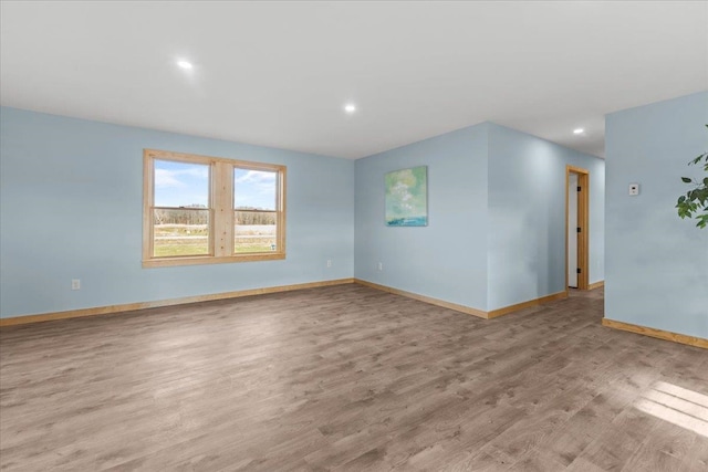 empty room with light hardwood / wood-style flooring