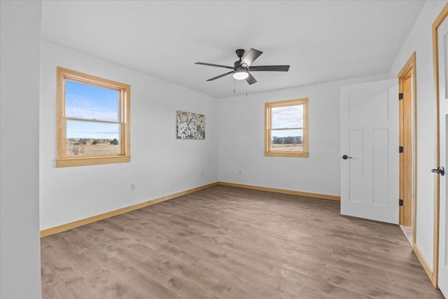 unfurnished room featuring ceiling fan and light hardwood / wood-style flooring