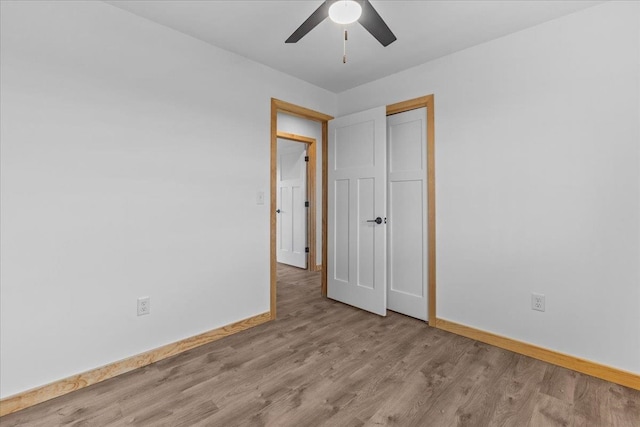 empty room featuring ceiling fan and light wood-type flooring