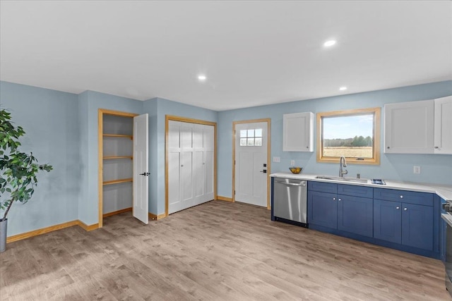 kitchen featuring dishwasher, sink, light hardwood / wood-style flooring, blue cabinetry, and white cabinetry