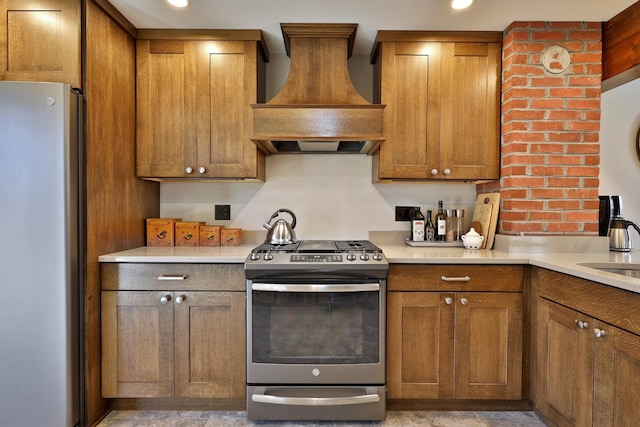 kitchen with appliances with stainless steel finishes and premium range hood