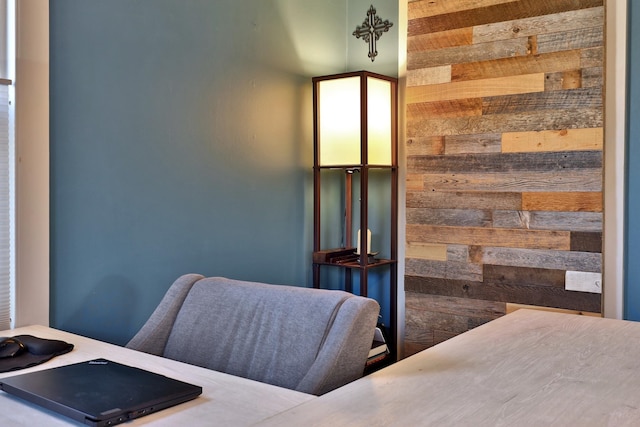 bedroom featuring wood walls